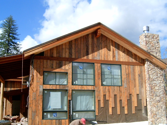 Brown barnwood siding being installed / light brown 8"